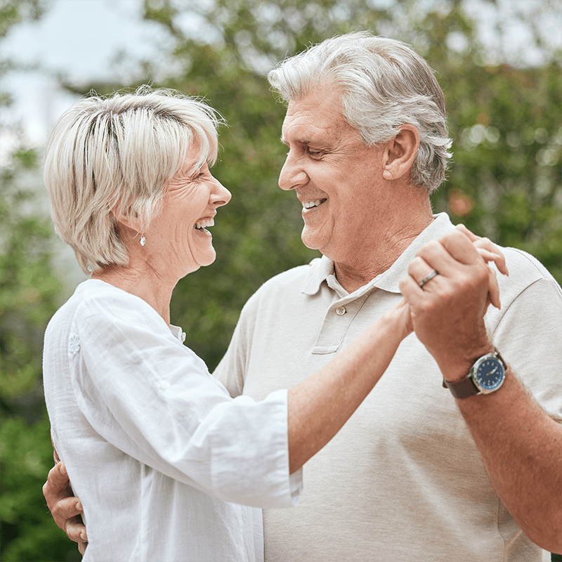 happy senior couple holding hands